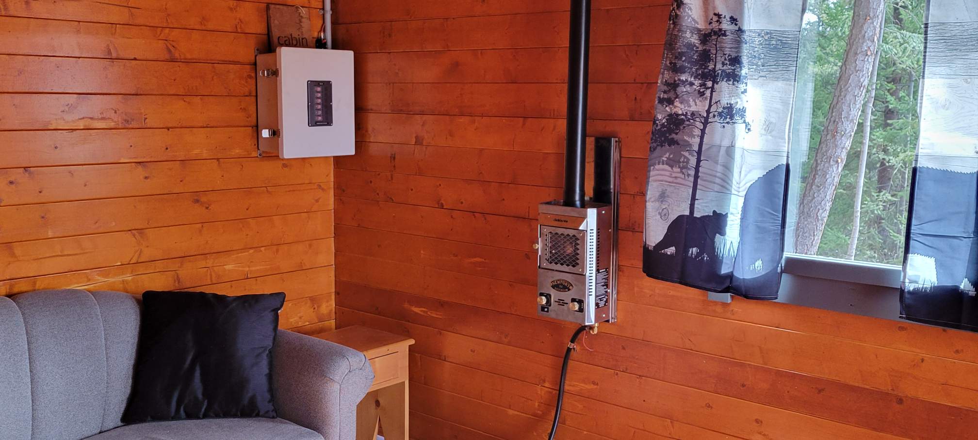 Propane heater and window inside the Big Cat Ranch cabin