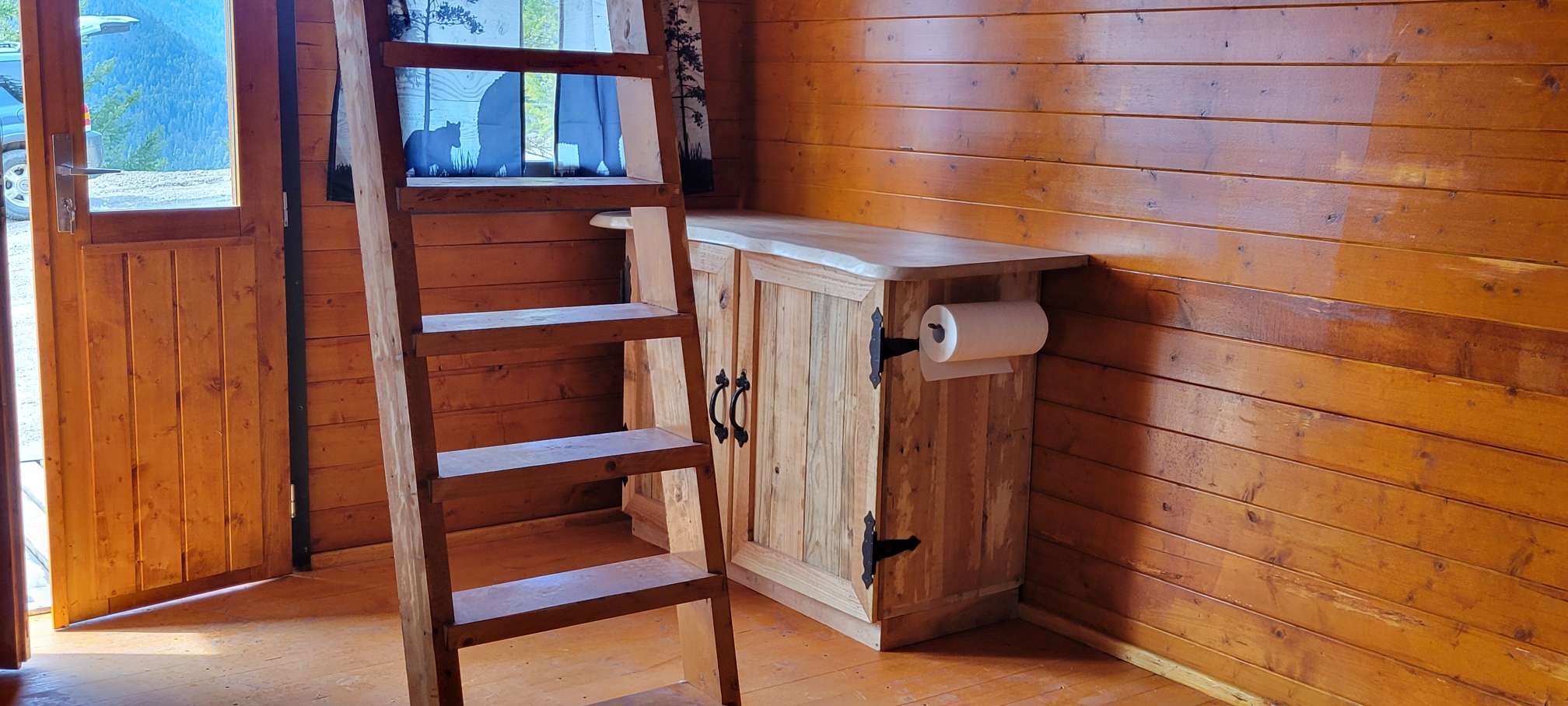 Wood ladder and cabinet inside the Big Cat Ranch cabin