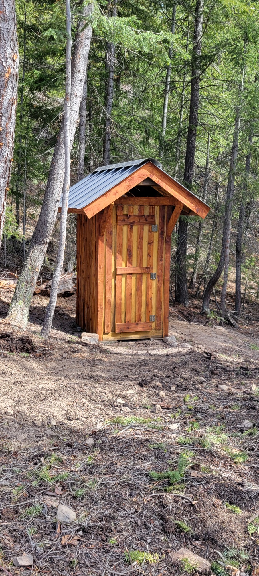 Wood outhouse near the Big Cat Ranch cabin in the forest